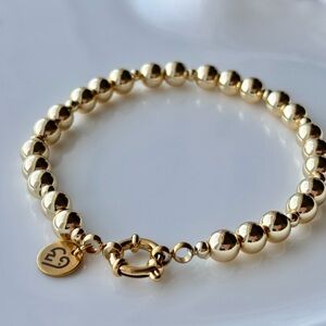 Gold Beaded Bracelet with Signature Charm